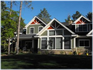 Painting exterior siding and detailed trim on a northern Minnesota home